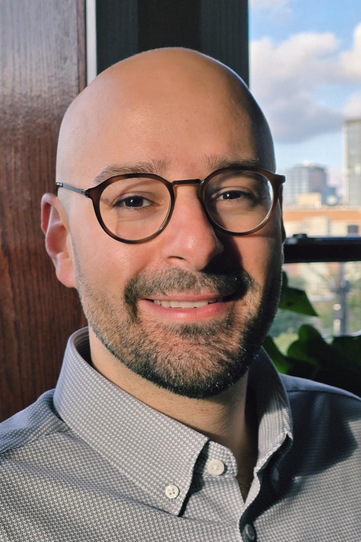 Doctor Motaz Alshami wearing glasses and smiling. Dr. Alshami is a board certified psychiatrist providing mental health care in Chicago and Illinois